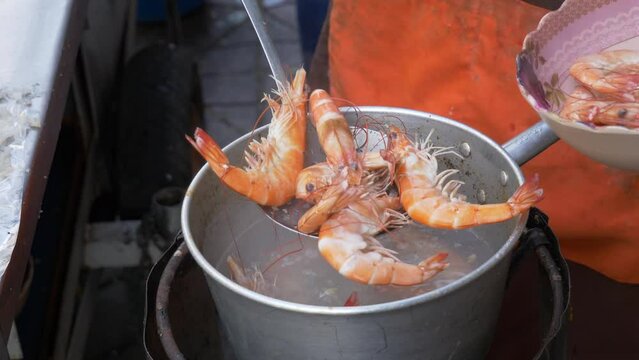 Boiling shrimps in water at street food restaurant