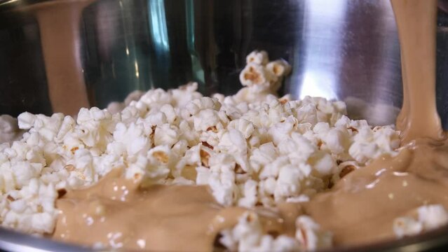 cooking popcorn at home in a special machine caramel. filling caramelized popcorn recipe close-up delicious treat for movie