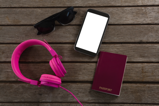 Digital png illustration of smartphone, sunglasses and passport on transparent background