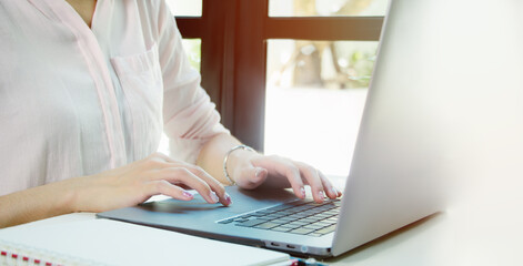 Hands of young contemporary office manager over laptop keypad during work