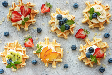 Freshly baked waffles with strawberries and blueberries