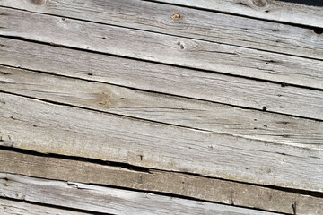 The texture of old wooden planks arranged diagonally. Gray wooden boards. Background texture.