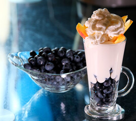 a sort of healthy breakfast with yougurt and berries in studio minimalist clip on blue background. High quality 4k footage