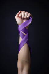 International Day for the Elimination of Violence against Women - Arm with violet ribbon