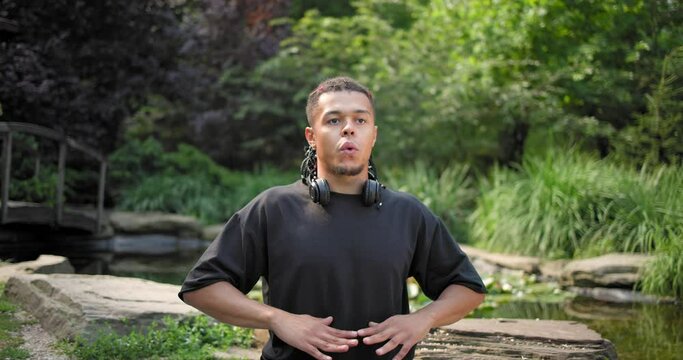 Calm mindful young african american man meditating doing exercise practicing yoga breathing for peaceful mind and zen