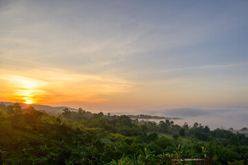 Morning sunrise with morning light on the mountain top with beautiful white mist sea of nature in Thailand.