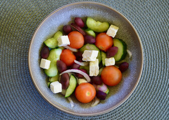 A bowl of Greek salad on the table