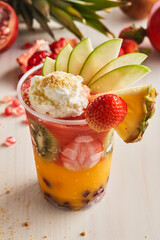 lebanese cocktails include pineapple, kiwi, strawberry, mango, pomegranate fruit slice served in glass isolated on table top view of healthy morning drink