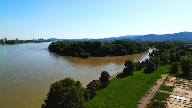 Lush Vegetation And Tranquil River In Obuda Island, Budapest, Hungary - aerial drone shot