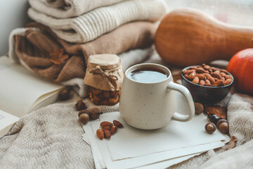 Cup of tea and almonds in autumn decor, good morning concept