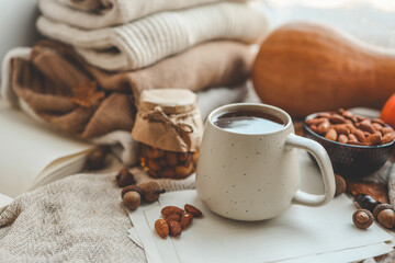 Cup of tea and almonds in autumn decor, good morning concept