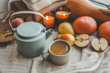 Teapot and cup with sea buckthorn tea, autumn mood
