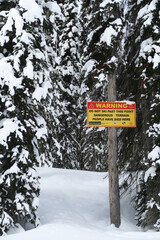 warning sign in the forest of revelstoke in canada