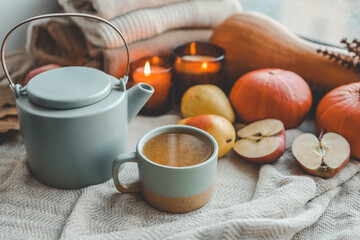 Teapot and cup with sea buckthorn tea, autumn mood