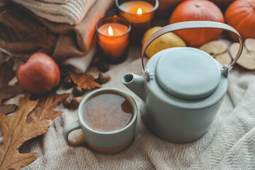 Teapot and cup with sea buckthorn tea, autumn mood