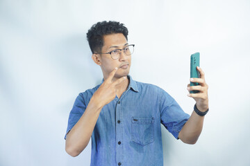 Hello. Happy millennial man wave hand hi look at smartphone screen start talk by video call with friend dating in videochat. Smiling young male begin phone conversation in conference app record vlog