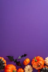 Deurstickers Dive into Halloween fun with this creative arrangement. Vertical top view shot of thematic decor, petite pumpkins, spectral spider, bats on violet backdrop with a blank space for greetings or ads © ActionGP