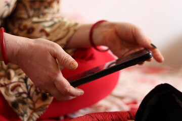 Closeup of An Indian lady Using Smartphone with selective focus 