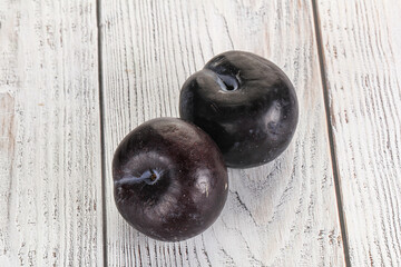 Two ripe sweet black plums