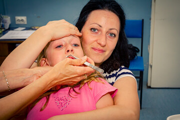 Obraz na płótnie Canvas Frightened sweet little girl at dentist, dental care