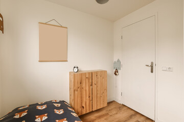 an empty room with a bed and wooden cabinet on the left handrails are hanging on the wall above it