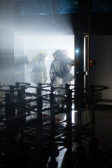 Firefighters are working in the airport at night. With the fire situation from terrorism