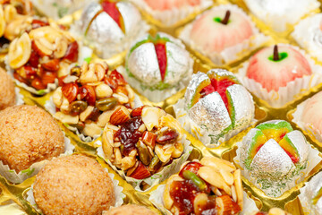 Close-up of different types of Indian sweets. Khoa Ladoo, Dryfruits Ladoo. Front view.