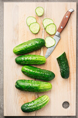 Fresh organic cucumbers on cutting board.
