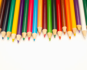 Colorful colored pencils on a white background in a creative workspace.