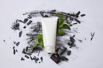 Scene for advertising facial cleanser with natural ingredient. Bamboo charcoal and green tea are a duo of ingredients that help clean the skin and naturally moisturize. Top view space for design