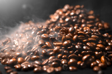 Closeup view of fresh roasted coffee beans with smoke