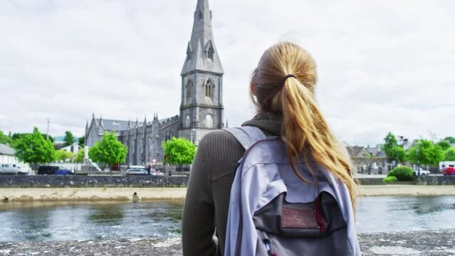 Woman Staring At St. Muredach's Cathedral In Ireland