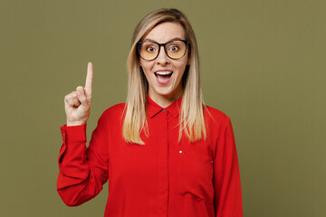 Young insighted smart proactive woman she in red shirt casual clothes glasses holding index finger up with great new idea isolated on plain pastel green background studio portrait. Lifestyle concept © ViDi Studio