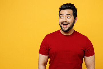Young surprised shocked astonished amazed stunned happy Indian man he wears red t-shirt casual...