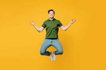 Fototapeta na wymiar Full body young spiritual man wears green t-shirt casual clothes jump high hold spread hands in yoga om aum gesture relax meditate try to calm down isolated on plain yellow background studio portrait.