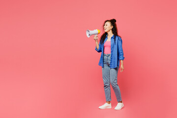 Full body young woman of African American ethnicity she wear blue shirt casual clothes hold in hand megaphone scream announces discounts sale Hurry up isolated on plain pastel pink background studio.