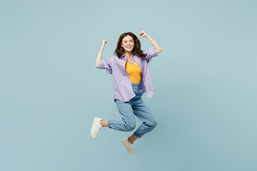 Full body young happy woman wears purple shirt yellow t-shirt casual clothes jump high do winner...