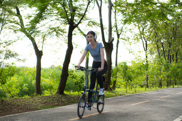 Fototapeta na wymiar Woman riding a bicycle in the park. Healthy lifestyle and sport concept.