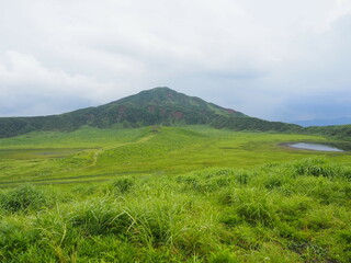 Kusasenri-ga-hama includes a rain fed pool and a 785,000-square-meter grassland growing inside an inactive crater in the foothills of Mt. Eboshi