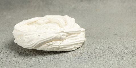 Multilayered meringue dessert on a light background, Long banner format