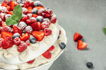 Pavlova cakes with cream and fresh berries on a light background, banner, menu, recipe place for text, top view