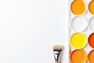 Watercolor paints and brush isolated on white background. Top view