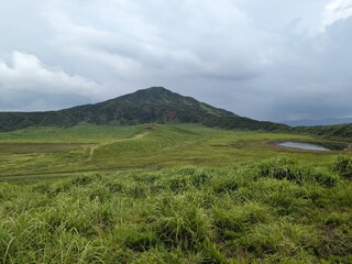 Kusasenri-ga-hama includes a rain fed pool and a 785,000-square-meter grassland growing inside an inactive crater in the foothills of Mt. Eboshi