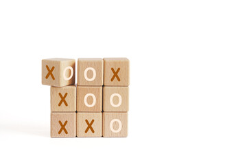 Business marketing strategy planning concept. Wooden block tic tac toe board game isolated on white...