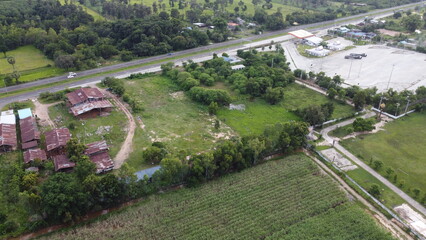 Aerial view of green fields and farmlands in rural Thailand.