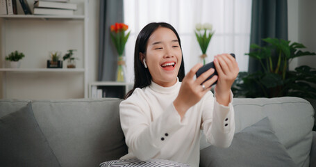 Asian woman playing a game on smartphone