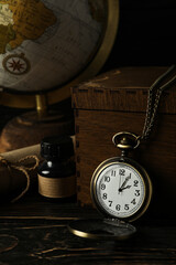 Columbus Day. Globe with a pocket watch on a dark background