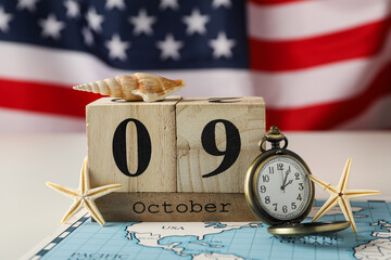 Columbus Day. Calendar with a clock on the background of the American flag