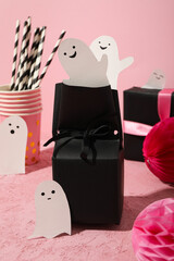 Gifts in black wrapping with ghosts on Halloween