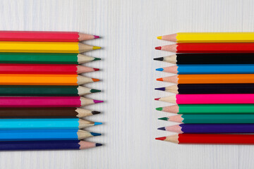Colored wooden pencils on a light background.